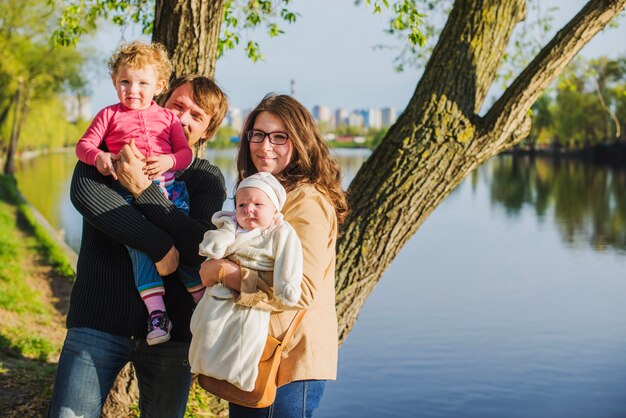 Cheerful family with their children by the lake