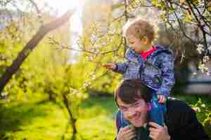 Free photo cheerful father with his son on his shoulders