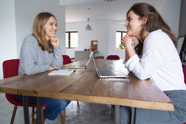 Free photo cheerful female students chatting