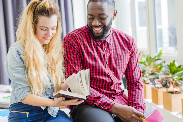 Free photo cheerful friends posing with books