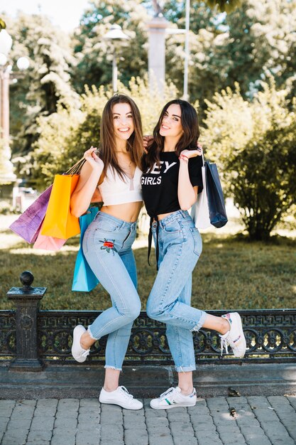 Cheerful friends with paper bags