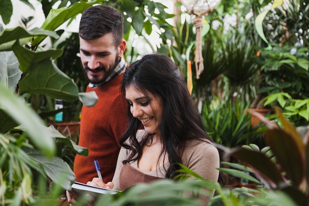 Cheerful gardeners making notes