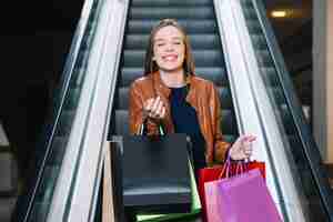 Free photo cheerful girl gesturing in mall