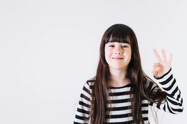 Cheerful girl gesturing OK