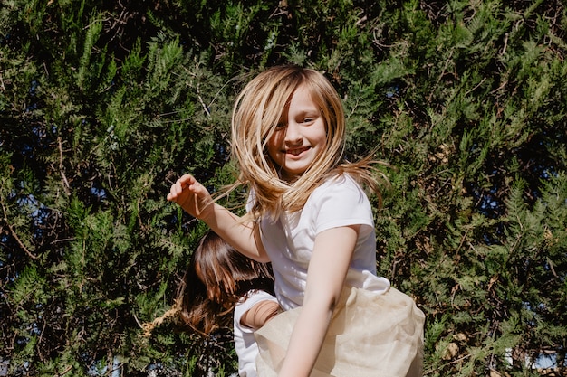 Free photo cheerful girl jumping near trees