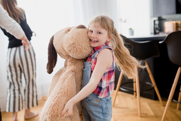 Free Photo cheerful girl with plush dog