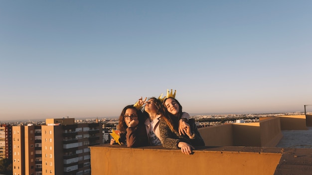 Free photo cheerful girls on roof