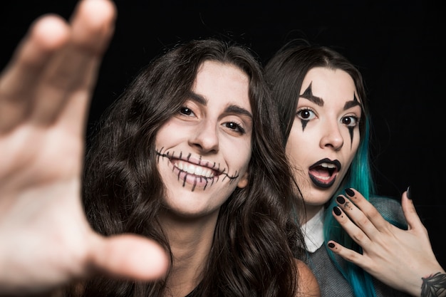 Free photo cheerful girls with spooky makeup