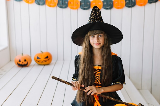 Free Photo cheerful halloween witch holding broom