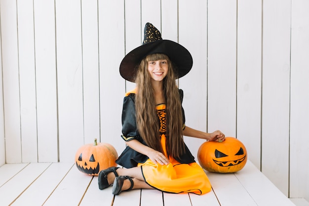 Free Photo cheerful halloween witch with jack-o-lanterns