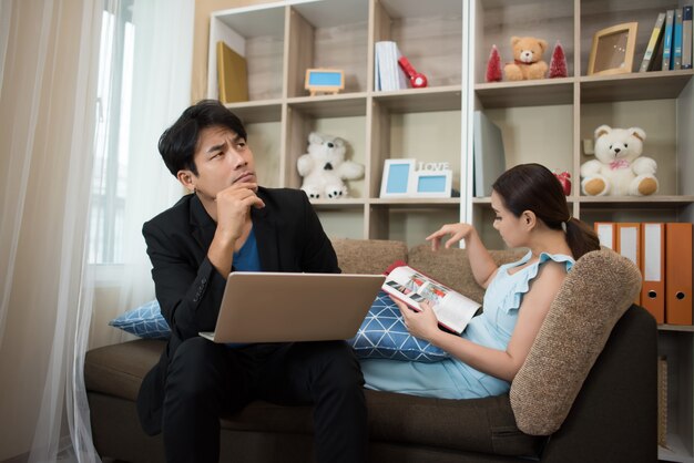 Cheerful Happy couple relaxing in sofa at home