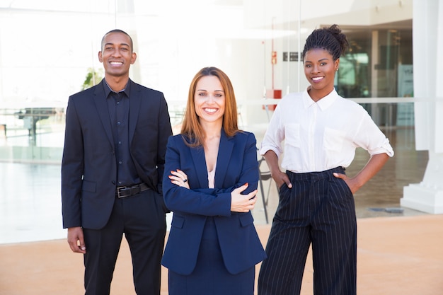 Cheerful intercultural business colleagues in formal outfits