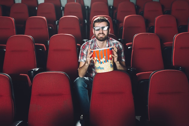 Cheerful man in cinema auditorium