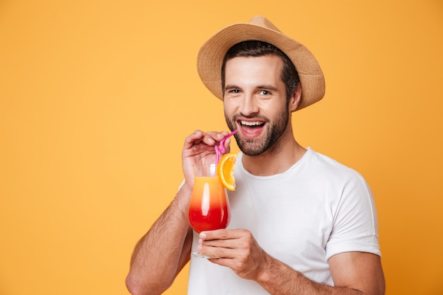 Cheerful man drinking cocktail