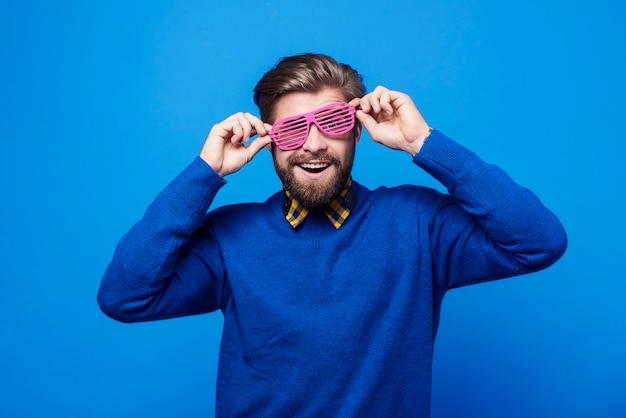 Free Photo cheerful man with sunglasses having a fun