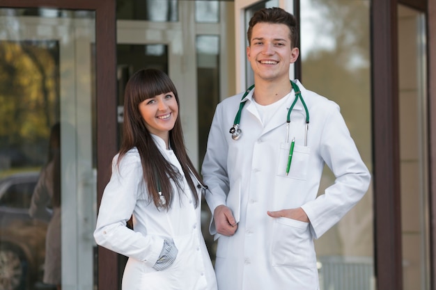 Cheerful man and woman doctors at clinic