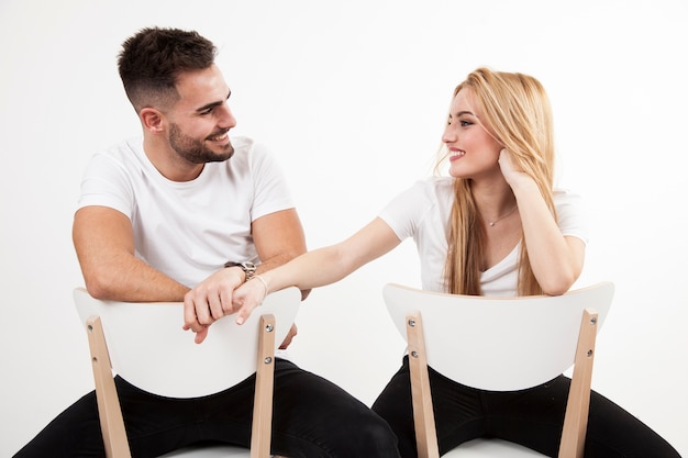 Cheerful man and woman holding hands