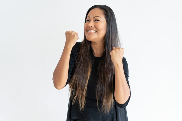 Cheerful middle-aged woman celebrating success