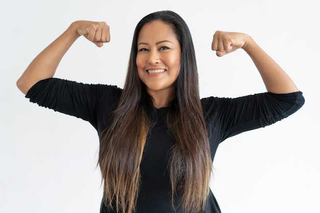 Cheerful middle-aged woman demonstrating power