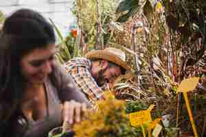 Free photo cheerful people working with plants