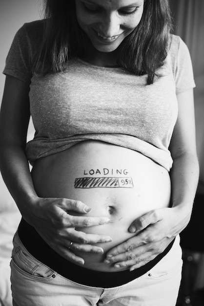 A cheerful pregnant woman waiting for her baby