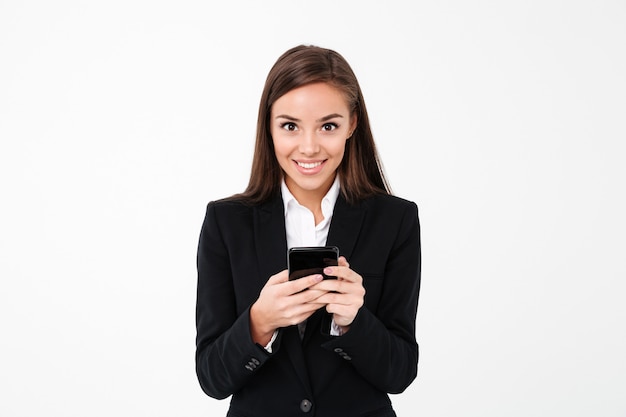 Cheerful pretty businesswoman chatting by phone