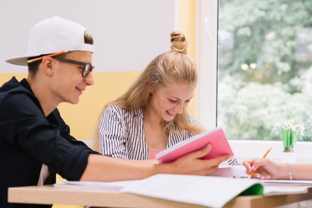 Cheerful school people with books