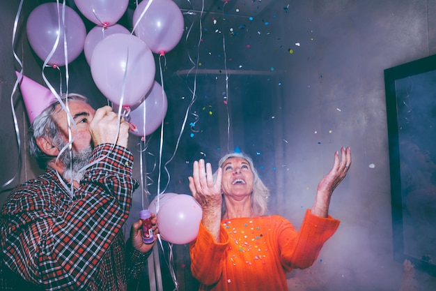 Cheerful senior couple enjoying the party