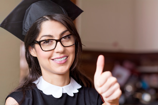 Cheerful student showing thumbs up