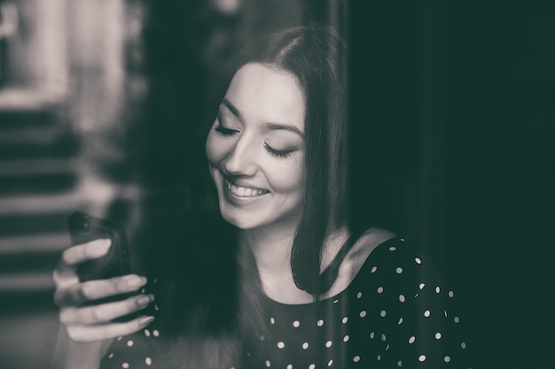 Cheerful student using her mobile phone