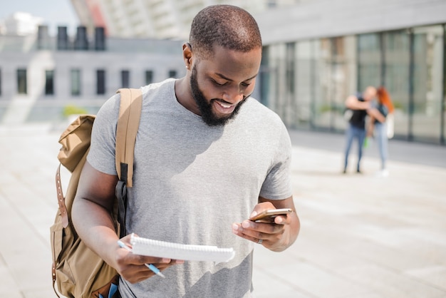 Cheerful student using phone