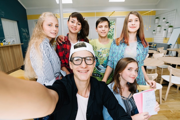 Free photo cheerful students looking at camera while posing