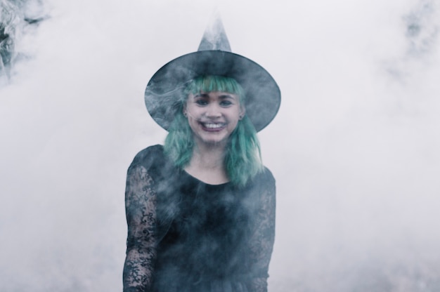 Free Photo cheerful witch girl in smoke