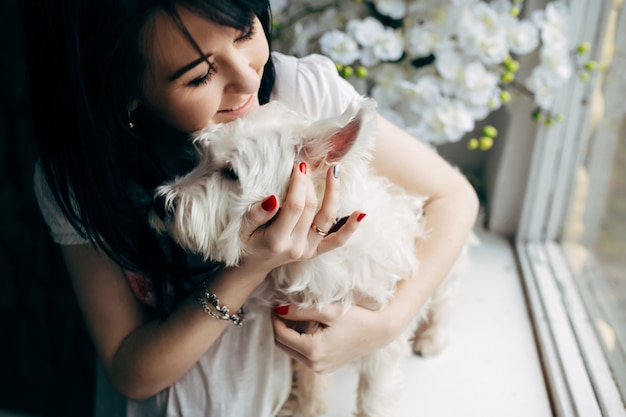 Cheerful woman cuddling with dog