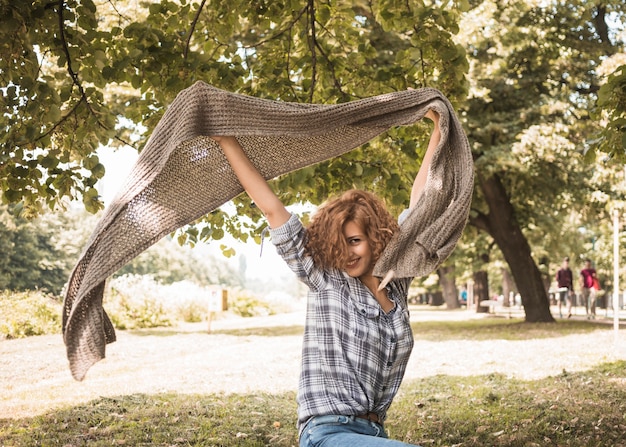 Free photo cheerful woman having fun with scarf