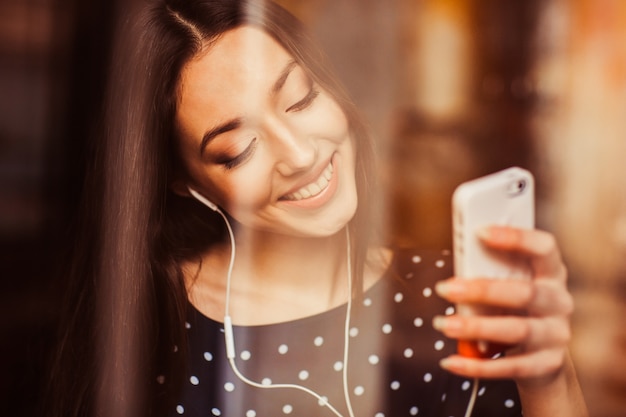 Cheerful woman looking at her mobile