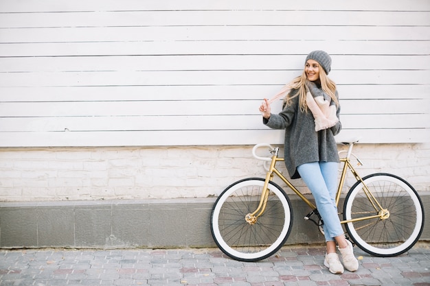 Cheerful woman near bicycle