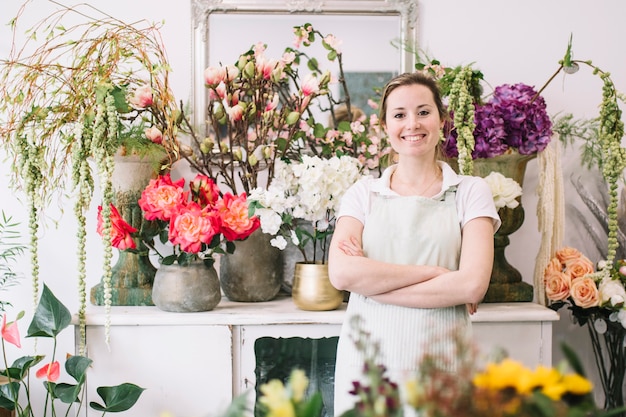 Cheerful woman posing near flowers