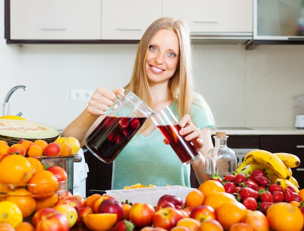 Free photo cheerful woman pouring beverages