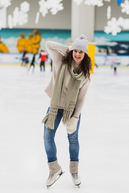 Cheerful woman on skating rink