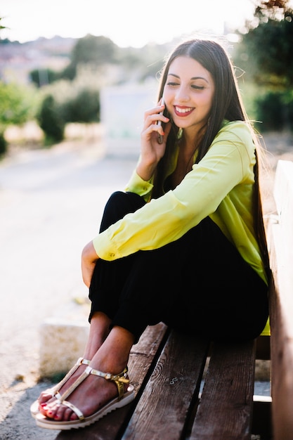 Cheerful woman talking phone