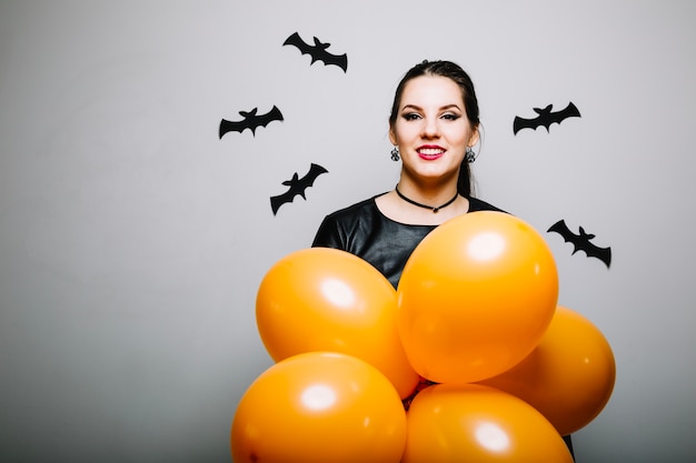 Cheerful woman with decor for Halloween