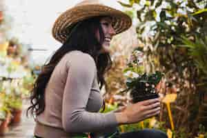 Free photo cheerful woman with potted flower