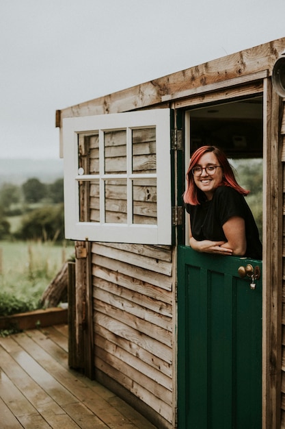 Free photo cheerful woman in a wooden house