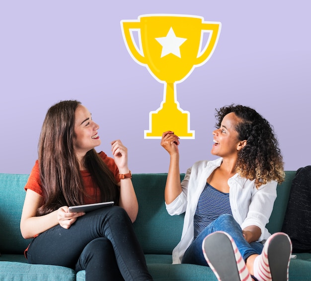 Cheerful women holding trophy icon