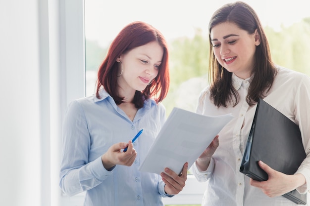 Free photo cheerful women working with documents