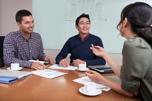 Cheerful young business people having brainstorming session