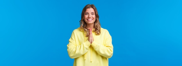 Free photo cheerful young european female practice yoga greeting sensei with namaste gesture hold hands in pray