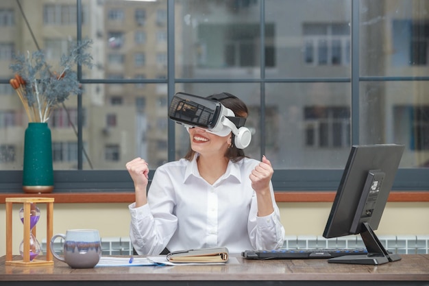 Free Photo cheerful young girl wearing vr device and squeeze her fists