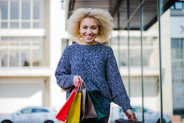 Free Photo cheerful young girl with purchases